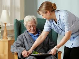 carer providing meal for older person at home